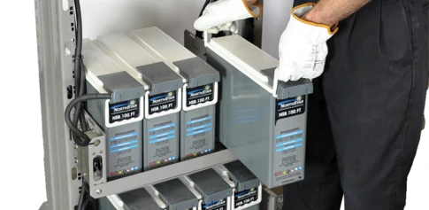 man installing critical power batteries