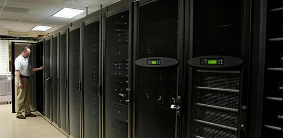 row of ups systems with a man in the background